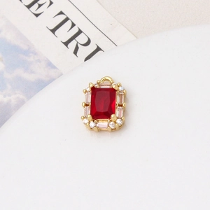 Macro shot of rectangular red zircon pendant with emerald cut in gold plated setting
