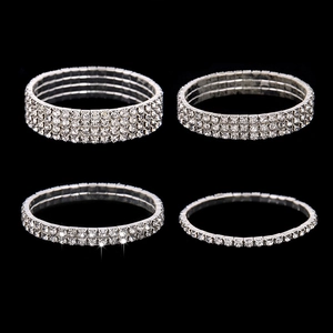 Set of flexible silver bracelets with multiple rows of sparkling white rhinestones