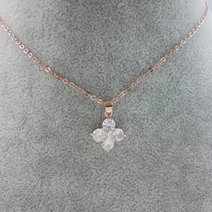Rose gold four-leaf clover pendant necklace with clear AAA zircon crystals on gray velvet