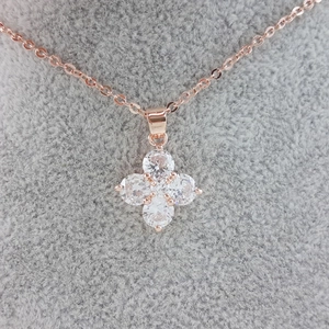 Elegant four-petal flower zircon pendant necklace in rose gold finish on display
