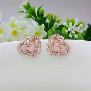 Elegant rose gold double heart stud earrings with white crystal rhinestones on white flowers