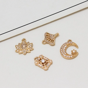 Set of four gold-plated moon and flower charms with micro-paved cubic zirconia