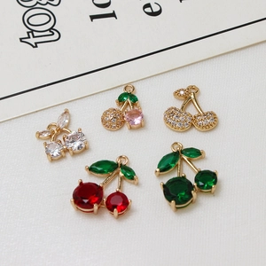 Macro shot of micro-pave zircon cherry charms in diverse colors for DIY jewelry