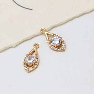 Macro detail of gold-plated copper teardrop pendants with micro-set zircon for DIY jewelry