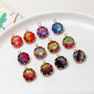 Detail of round faceted gradient faux tourmaline pendants with gold claw settings
