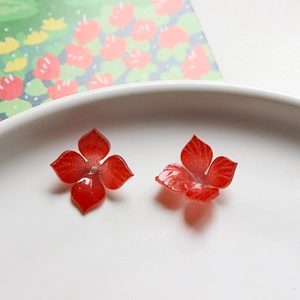 Macro-opname van rode hars bloembedeltjes voor DIY sieraden met bloemblad textuur
