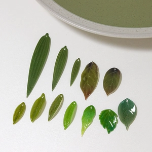 Green leaf resin pendants for DIY jewelry making in various shapes with pre-drilled holes