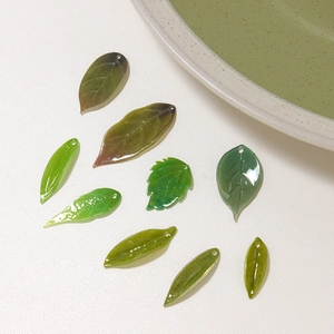 DIY bamboo leaf pendants in assorted green shades with pre-drilled holes for jewelry