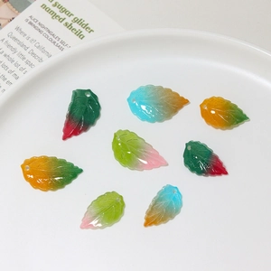 Detailed view of seven colorful gradient leaf pendants for DIY jewelry and hairpins