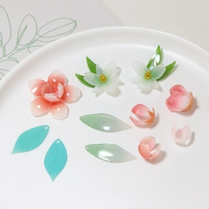 Detailed view of DIY resin camellia flower petals and translucent leaf craft beads