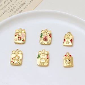 Set of six gold lucky charm pendants with traditional patterns for DIY jewelry making