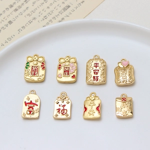 Macro detail of various gold lucky bag charms with Chinese characters in a ceramic bowl