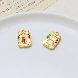 Macro detail of matte gold fortune pouch pendant with enamel Lucky Cat and charm details