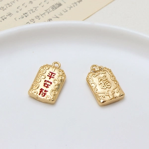 Macro view of gold plated lucky bag charms with Ping An and Fu characters for jewelry DIY