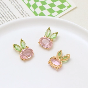 Detailed close-up of rabbit pendants with pink body and green marquise ears for DIY jewelry