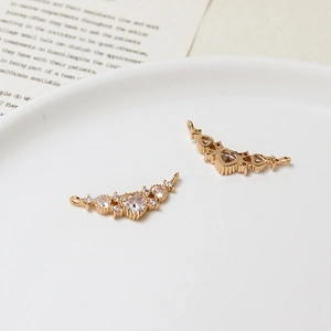 Detailed close-up of heart-shaped zircon connectors with gold plating for DIY jewelry