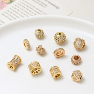Macro detail of micro-paved crystal zircon beads in various geometric shapes for DIY jewelry