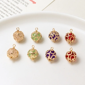 Close-up of filigree hollow metal charms with colorful crystal beads for DIY jewelry making