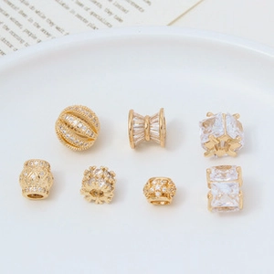 Macro detail of various gold-plated zircon spacer beads for DIY jewelry making