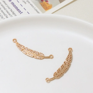 Detail of gold-plated feather connector with zircon pave for DIY jewelry making