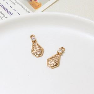 Close-up of gold geometric hollow pendants with zircon inlay for DIY jewelry making