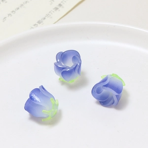 Macro shot of three purple gradient resin rose beads for DIY jewelry making accessories