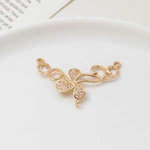 Macro shot of gold floral jewelry connector with zircons and three attachment loops