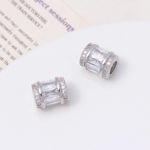 Macro view of silver-plated copper beads with zircon stones for DIY jewelry making
