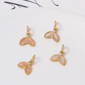 Detailed macro view of four cat eye fishtail charms for DIY jewelry making