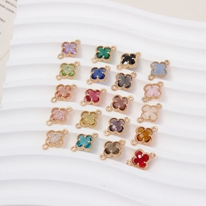 Macro-opname van gekleurde klaverhangers van kristalglas met gouden ringen voor DIY-sieraden
