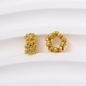 Vista macro de cuentas espaciadoras de flores doradas 3D para la creación de joyería