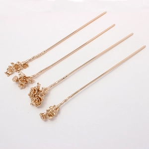 Detail view of four gold-plated flower hairpins with intricate floral and bud designs