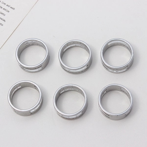 Top view of six minimalist silver double-layer open jump ring opening tools on white background