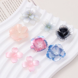Macro detail of various pastel 3D floral resin charms with pearlescent finish for DIY jewelry