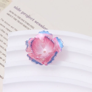 Detail view of pink and blue gradient resin flower charms for DIY jewelry making