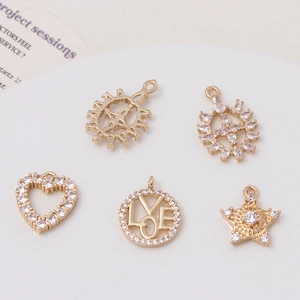 Detailed macro shot of heart and love charms crafted in gold plated copper and zircon