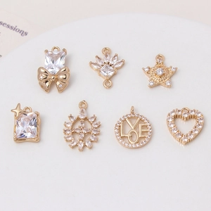 Set of seven gold plated charms with bow, star, and heart shapes for DIY jewelry making