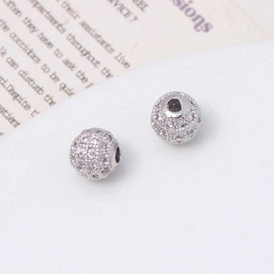 Macro detail of micro-pavé cubic zirconia silver charms for DIY jewelry making
