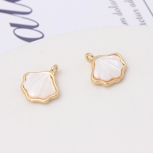 Close-up of gold-plated shell pendants with iridescent mother of pearl inlay for DIY jewelry