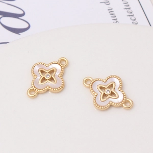 Detail of four-leaf clover connector with white shell inlay and zircon center for DIY