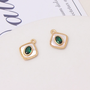 Close-up of vintage square shell pendants with green gems for DIY jewelry making