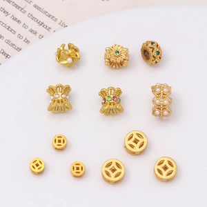 Detalle de cuentas y espaciadores de flores doradas para creación de joyas DIY