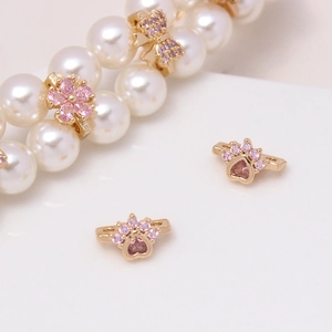 Detail showing gold flower and butterfly spacer beads with pink zircon on pearl strand