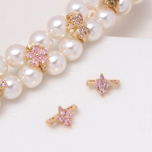 Detailed view of gold plated flower and butterfly zircon spacers for pearl jewelry