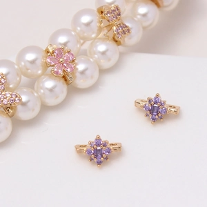 Macro view of colorful zircon flower and butterfly charms on a pearl necklace