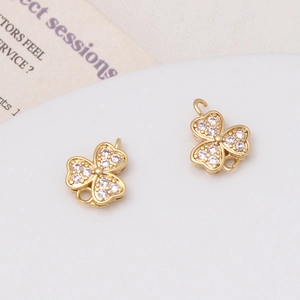 Close-up of gold clover charms with sparkling cubic zirconia for DIY jewelry making