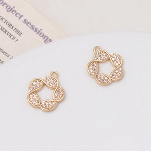 Detail of gold-plated flower pendants with pavé-set cubic zirconia and hanging loops