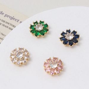 Macro detail of daisy spacers with colorful zircon marquise petals in gold finish
