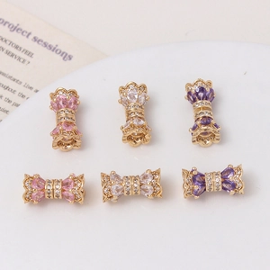 Macro detail of 14K gold plated zircon butterfly and cylinder clasps for jewelry making