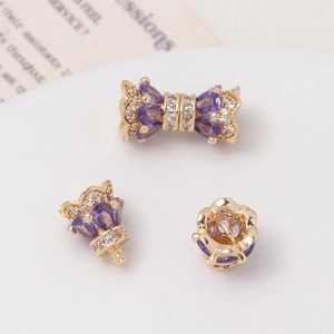 Macro view of gold-plated crown clasps with purple heart zircons and intricate crystals
